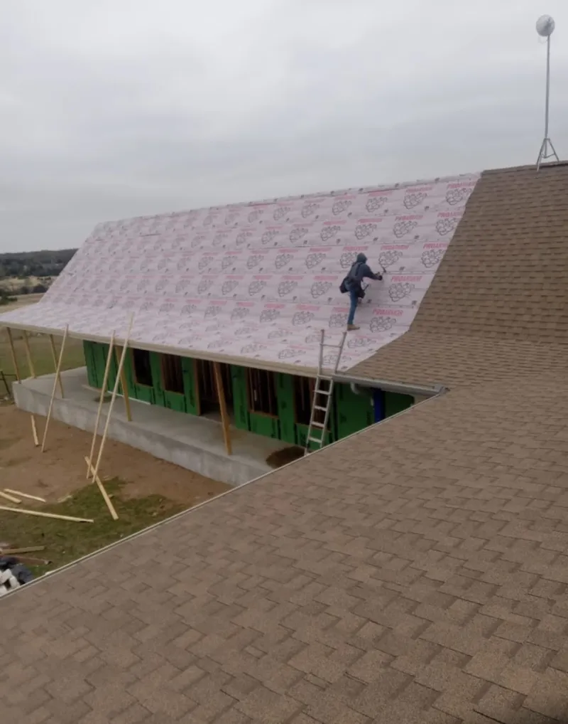 Worker preparing underlayment for a metal roof installation in Islamorada, Village of Islands